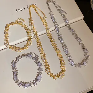 Detailed view of gold and silver necklaces with irregular square zircon patchwork.