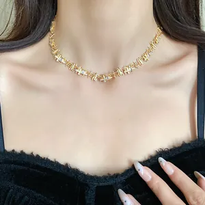 Close-up of elegant gold choker necklace with irregular square zircon patchwork