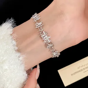 Detailed view of silver zircon bracelet with irregular square pattern on wrist.
