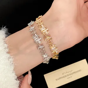Macro detail of elegant gold and silver irregular zircon link bracelets on a wrist