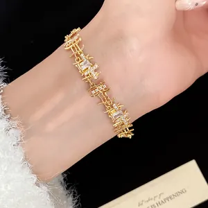 Detailed close-up of an elegant gold-toned zircon bracelet with unique irregular metal links