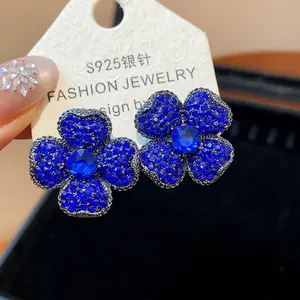 Detailed macro view of sparkling blue crystal flower earrings with S925 silver needles