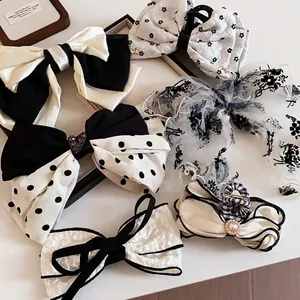 Elegant collection of black and white fabric bow hair clips and shark clips for women