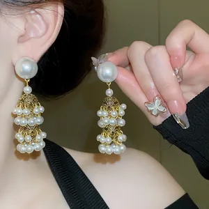Close-up of French vintage pearl tassel earrings with gold-tone metal detail