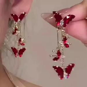 Detailed close-up view of elegant red butterfly tassel earrings with zircon crystal stones