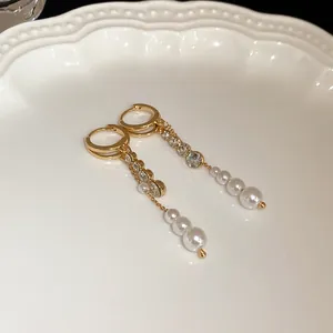 Detail view of French vintage earrings with rhinestones and elegant pearl tassels