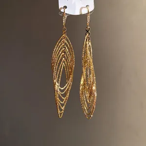 Elegant vintage gold layered oval dangle earrings featuring shimmering cubic zirconia
