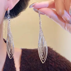 Elegant vintage-style metal drop earrings with tiered hollow oval design and zircon