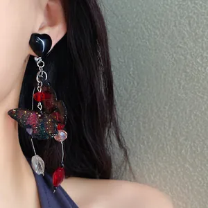 Detailed view of an elegant butterfly tassel earring, perfect for a seaside holiday style look.