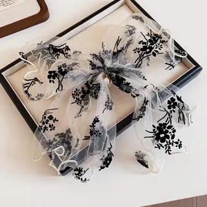 Elegant white mesh bow hair claw clip with black floral embroidery and a pearl pendant