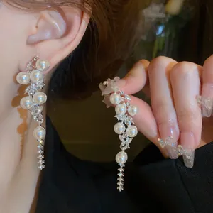 Close-up of elegant French vintage pearl tassel earrings with sparkling rhinestones