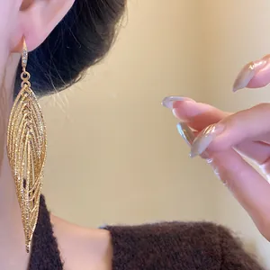Detailed view of luxury gold multi-layer hollow-out drop earring featuring sparkling zircons