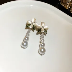 Elegant French vintage floral stud earrings featuring graduated white pearl tassels