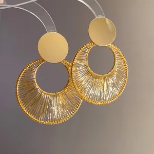 Detailansicht eleganter, goldener, drahtumwickelter hohler runder Ohrhänger für Damen