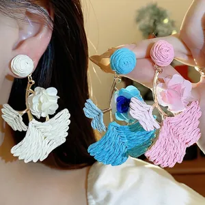 Handmade raffia ginkgo leaf drop earrings with delicate fabric flowers for vacation style