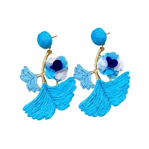 Blue raffia ginkgo leaf dangle earrings with floral accents for vacation style