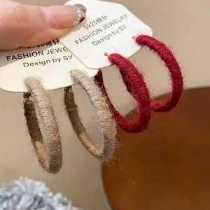 Close-up view of burgundy and khaki fabric woven hoop earrings on S925 silver needles cards.
