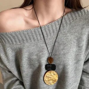 Vintage geometric resin pendant sweater chain on a long black leather cord