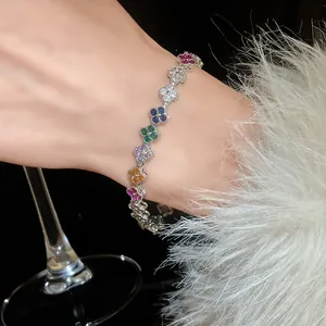 Detail shot of a micro-pave rainbow cubic zirconia lucky clover bracelet worn on wrist