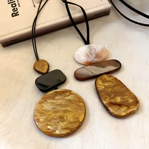Detailed view of vintage geometric resin pendants with elegant marble-like patterns