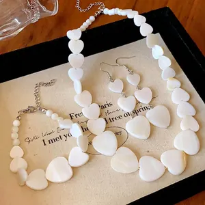 Minimalist mother-of-pearl heart necklace and earring set for an elegant fashion style