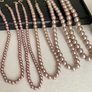 Detailed close-up showing various pearl necklace bead sizes in champagne and pink tones