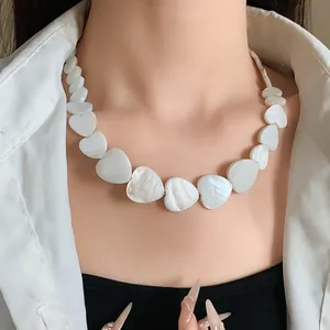 Elegant close-up detail of irregular heart-shaped mother of pearl shell necklace