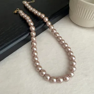Detailed close-up showing the lustrous texture of champagne pearl necklace beads