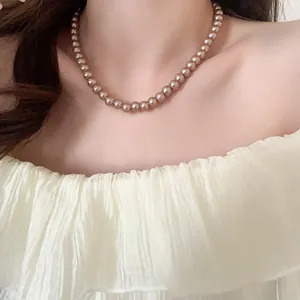 Close-up of champagne pearl necklace worn on neckline for elegant vintage style