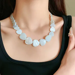 Close-up of minimalist heart-shaped shell necklace with natural iridescent luster