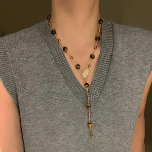 Vintage tiger eye beaded long sweater necklace with leaf pendant on model