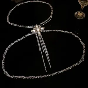 Elegant silver-tone body chain featuring pearl flower and rhinestone tassels on black background