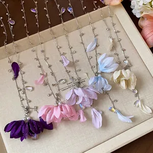 Elegant fabric flower necklaces with rhinestone teardrops in various pastel colors.
