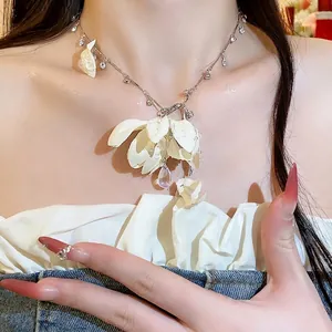 Elegant fabric flower necklace with rhinestone water-drop pendant on model's neck