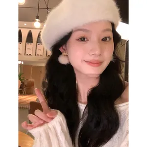 Model wearing elegant white flocked pom pom flower earrings for autumn and winter