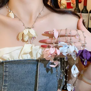 Detailed view of multi-color fabric flower necklaces with rhinestones and drop pendants.
