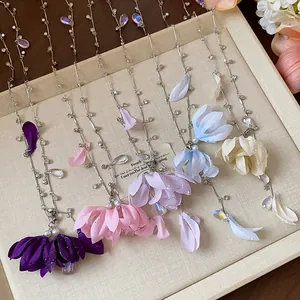 Macro detail of elegant fabric flower necklaces with rhinestones and teardrop beads