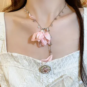 Detailed close-up of pink fabric flower necklace with rhinestone and crystal drops
