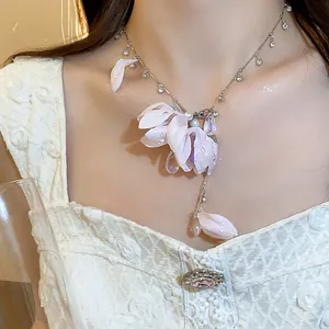 Close-up of elegant pink cloth flower necklace with rhinestones and waterdrop crystals