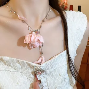 Detail of pink fabric flower necklace with rhinestones and decorative water droplets