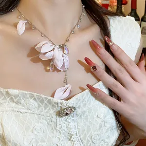 Elegant fabric flower necklace with crystal water drops worn by a female model