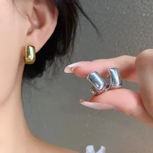 Minimalist geometric acrylic hoop earrings in gold and silver glossy finish.