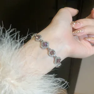 Exquisite silver-toned bracelet with sparkling pink stone floral and round charms
