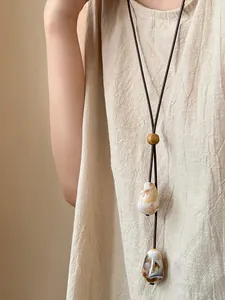 Long leather cord necklace with magnetic sunglass holder and minimalist stone beads.