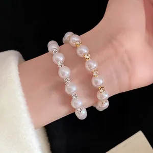 Elegant French retro style pearl cuff bracelet with crystal spacers on a female wrist