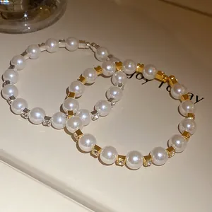 Close-up of French vintage pearl bracelets with gold and silver rhinestone accents