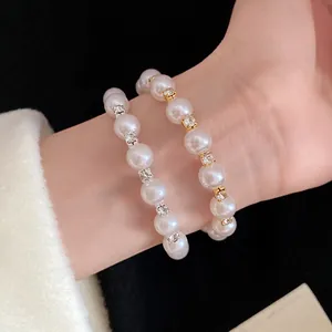 Close-up of elegant pearl beaded bracelet with sparkling rhinestone accents on wrist