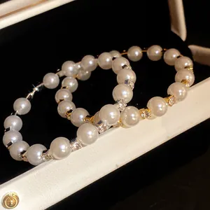 Macro detail of French vintage style open bangle with pearls and rhinestones