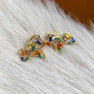 Detailed close-up of 18K gold-plated horse earrings with vibrant rainbow zircons.