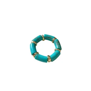 Bohemian vintage stretch bracelet with turquoise marbled cylindrical beads and gold spacers